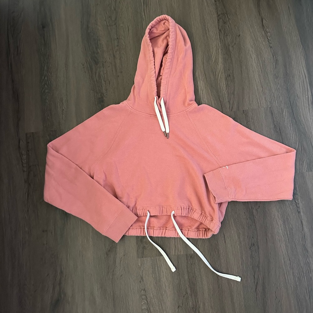 A pink crop top hoodie from Hollister.